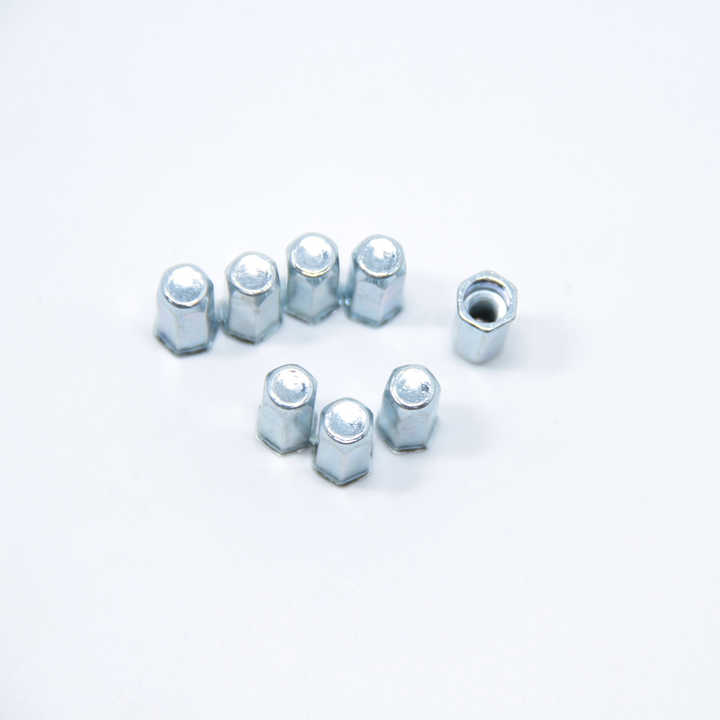 Assorted threaded rivet nuts on a white surface